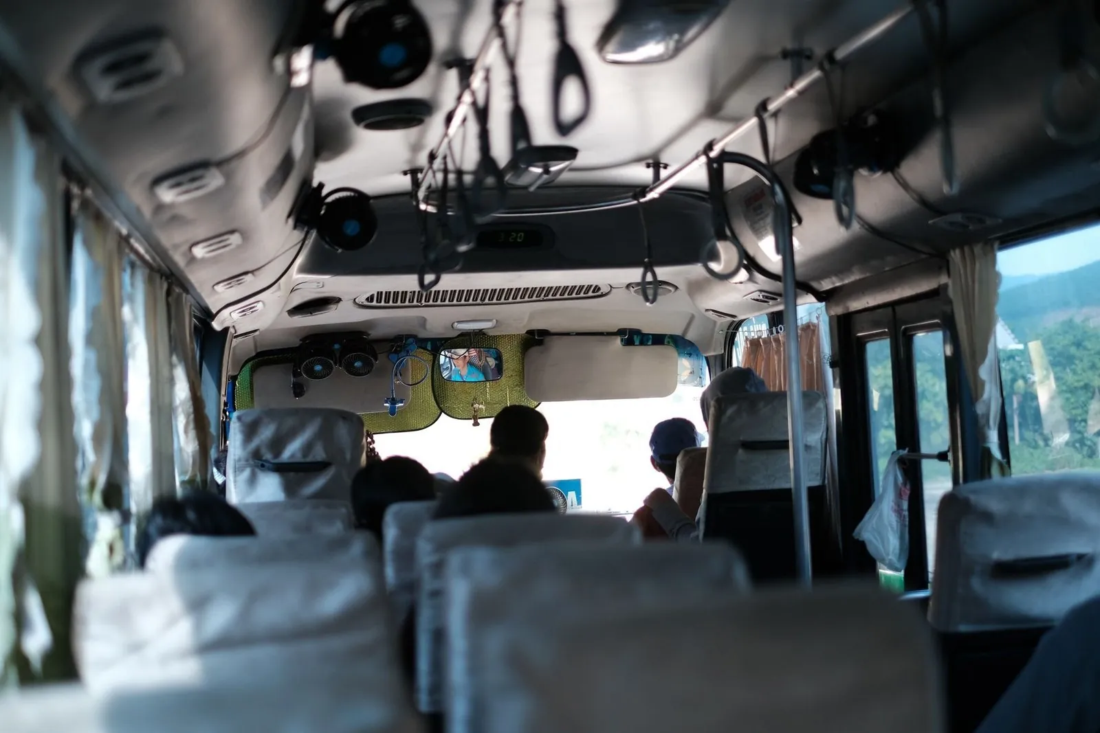 Inside a coach bus seat row with a mountain view