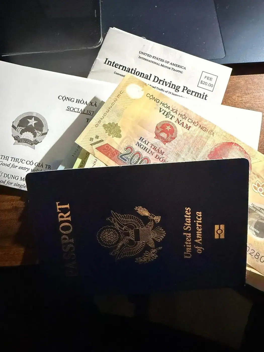Passport and Vietnam e-visa documents on a desk