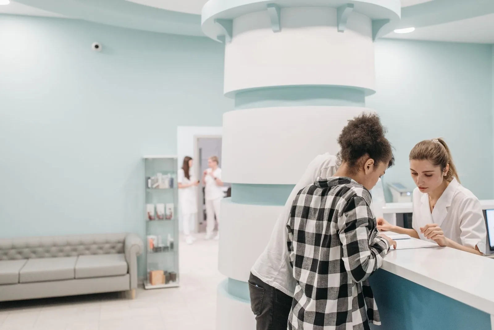 Patient checking in at a clinic reception desk
