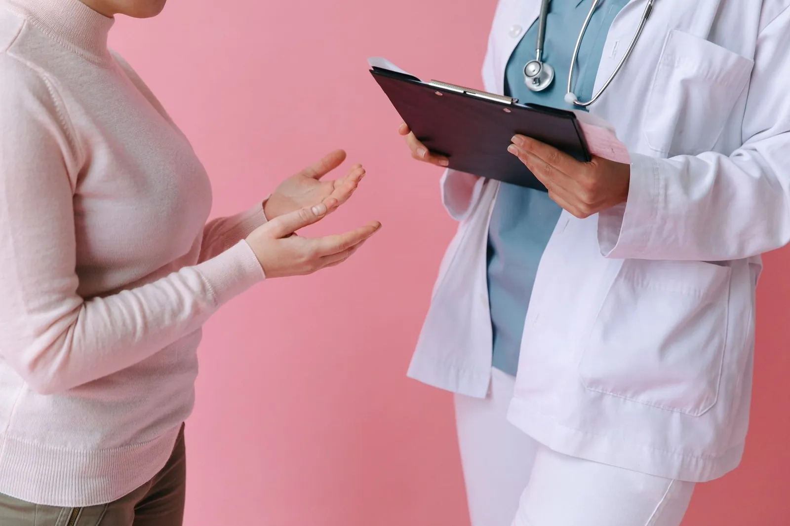 Doctor consulting a patient with a clipboard