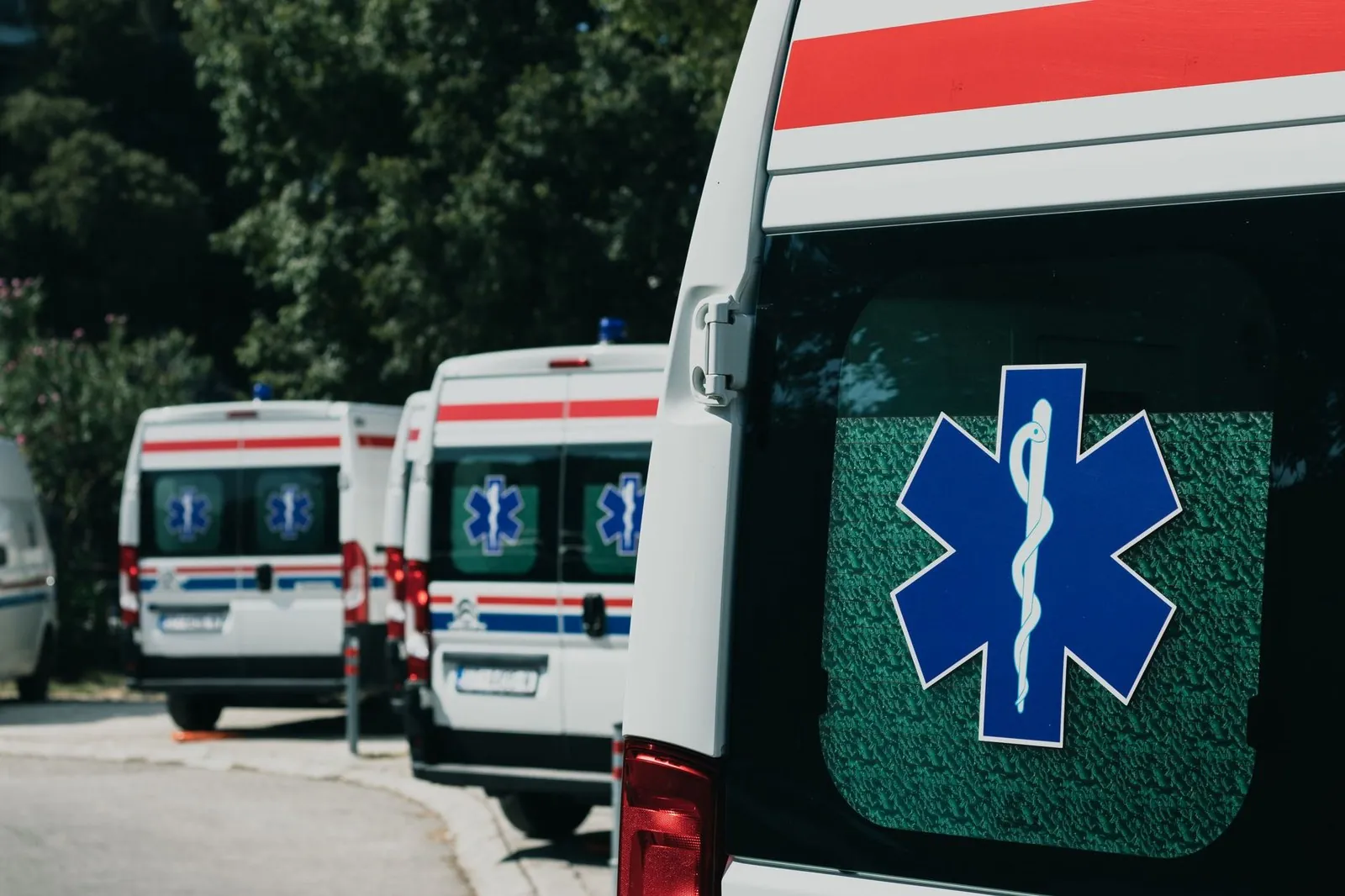 Row of ambulances parked outside a hospital