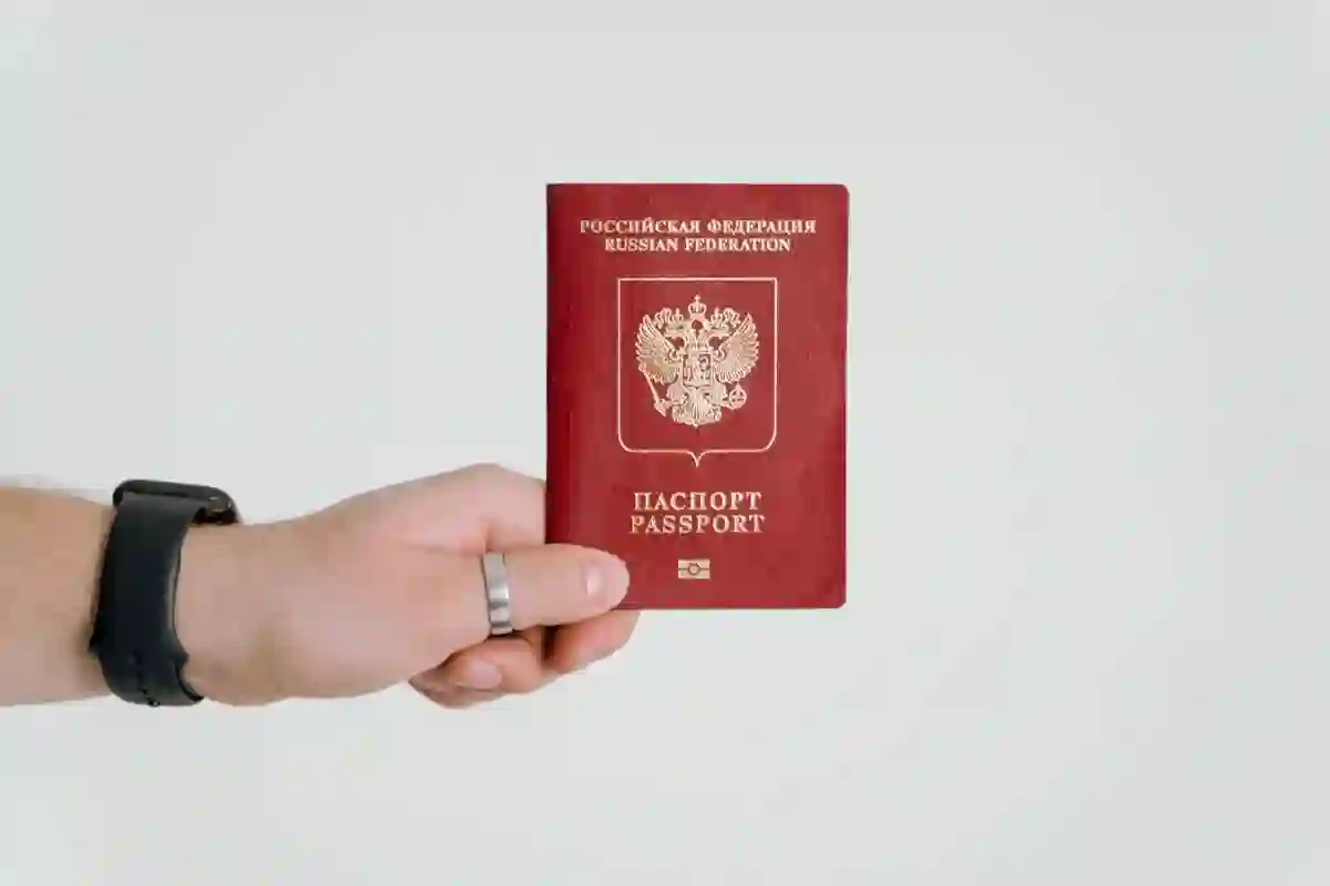 Hand holding passport for visa application at Da Nang immigration office