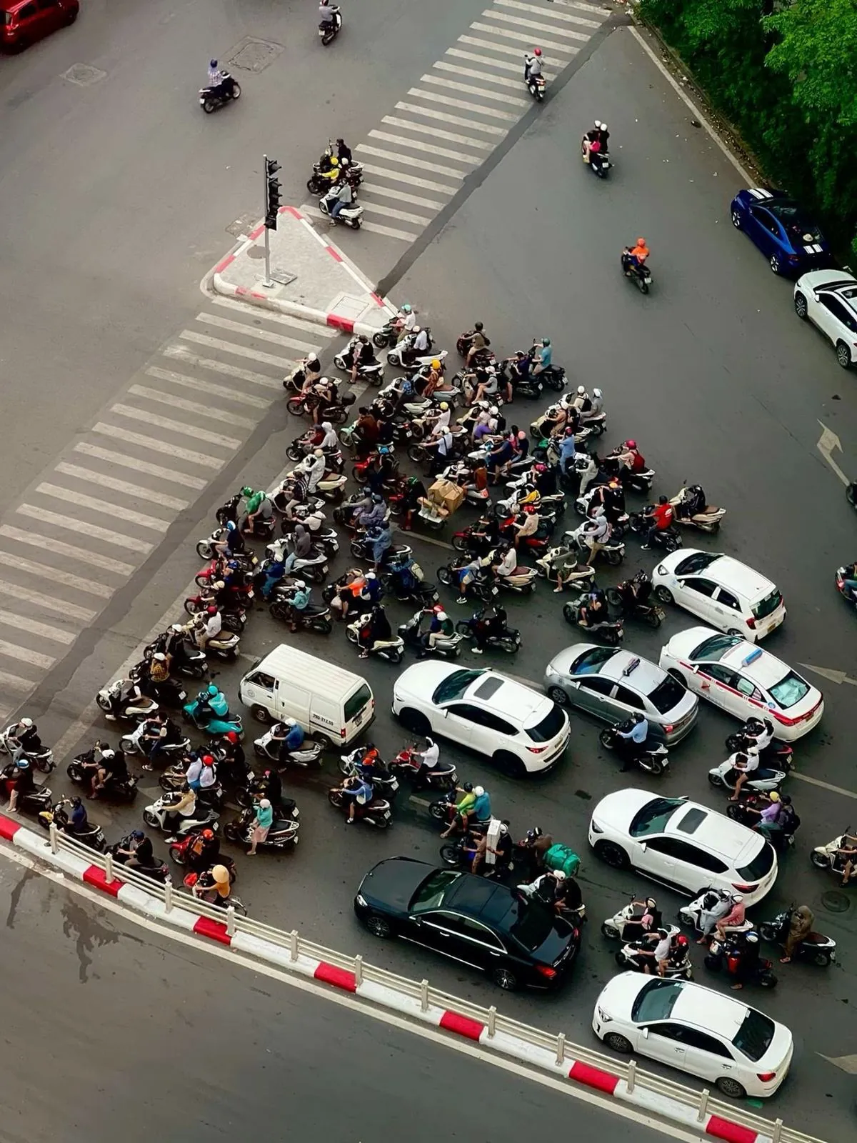 Aerial view of a packed motorbike intersection among cars