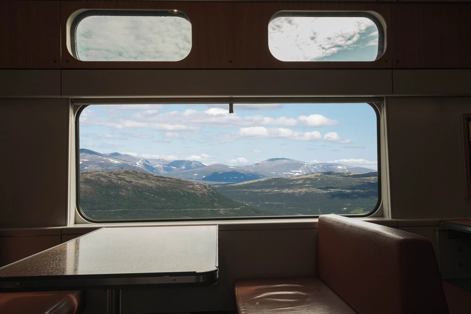 View from a train window overlooking a mountainous landscape