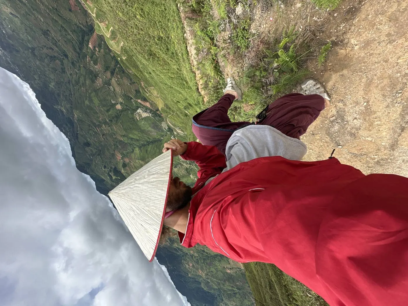 Selfie on a rocky Ha Giang mountain trail above a deep valley