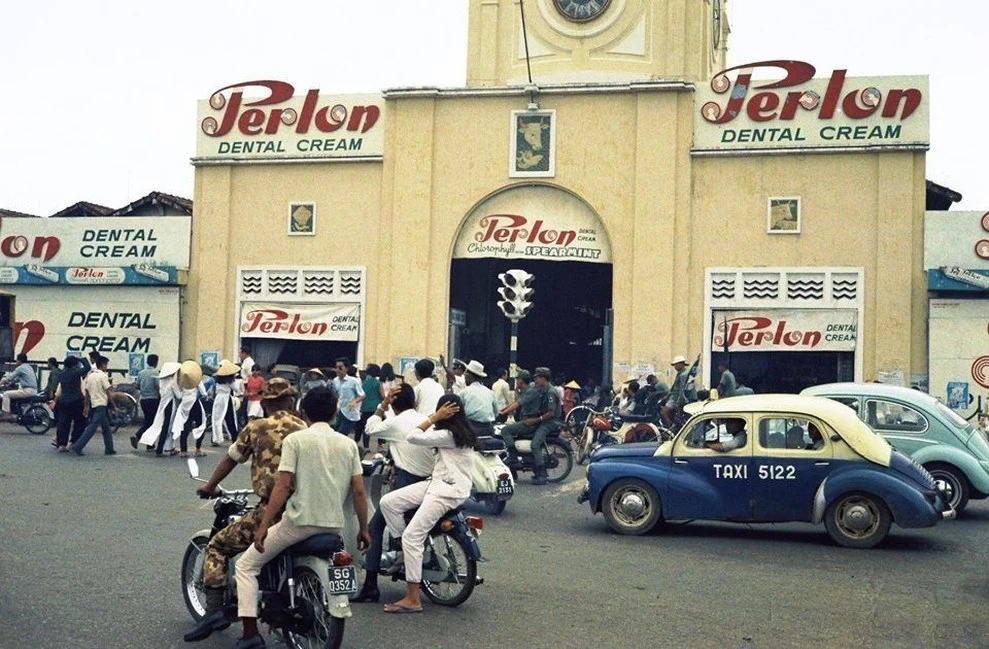Street in Ho Chi Minh City with a shop and an old car