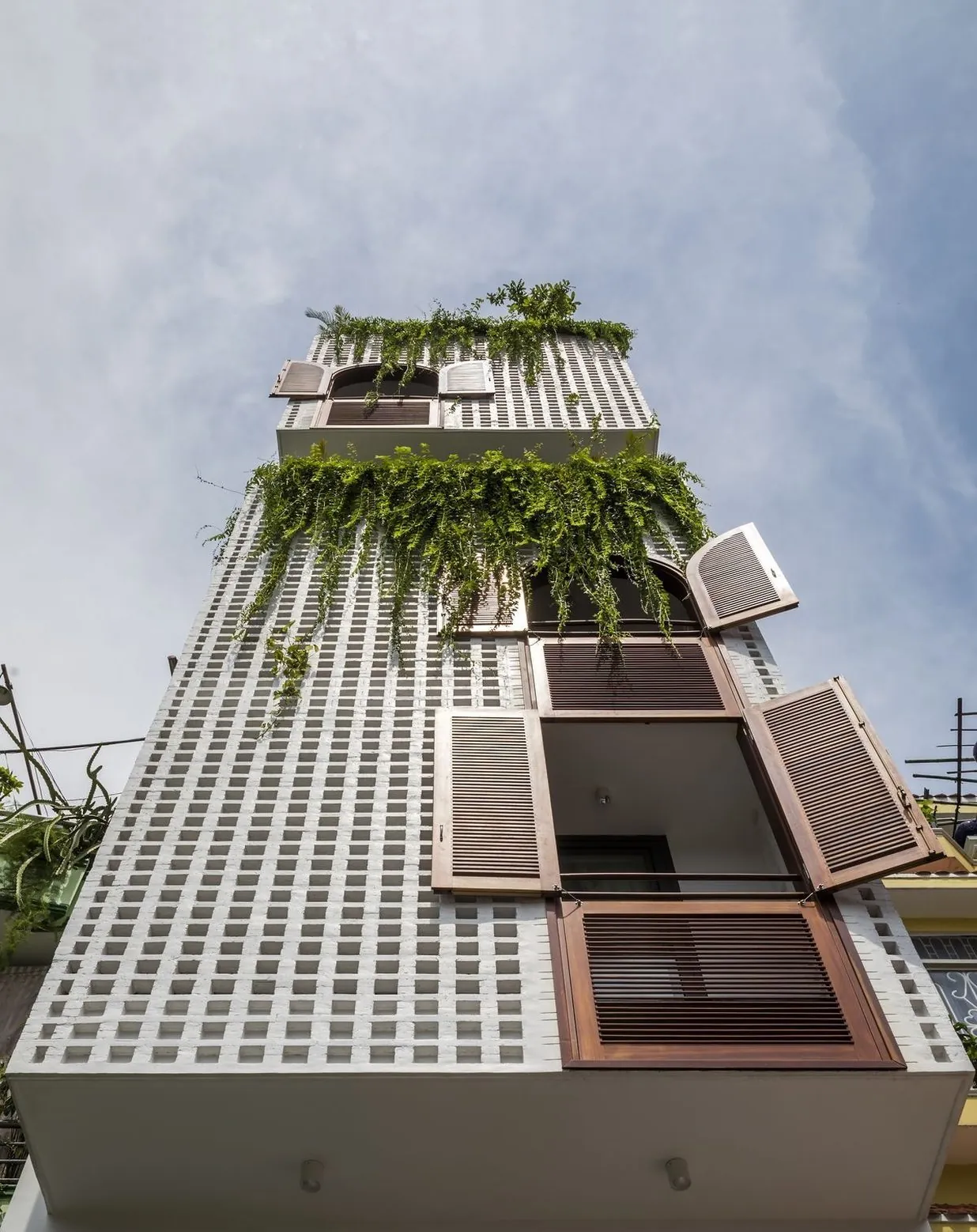 Modern Da Nang house facade with greenery and wooden shutters