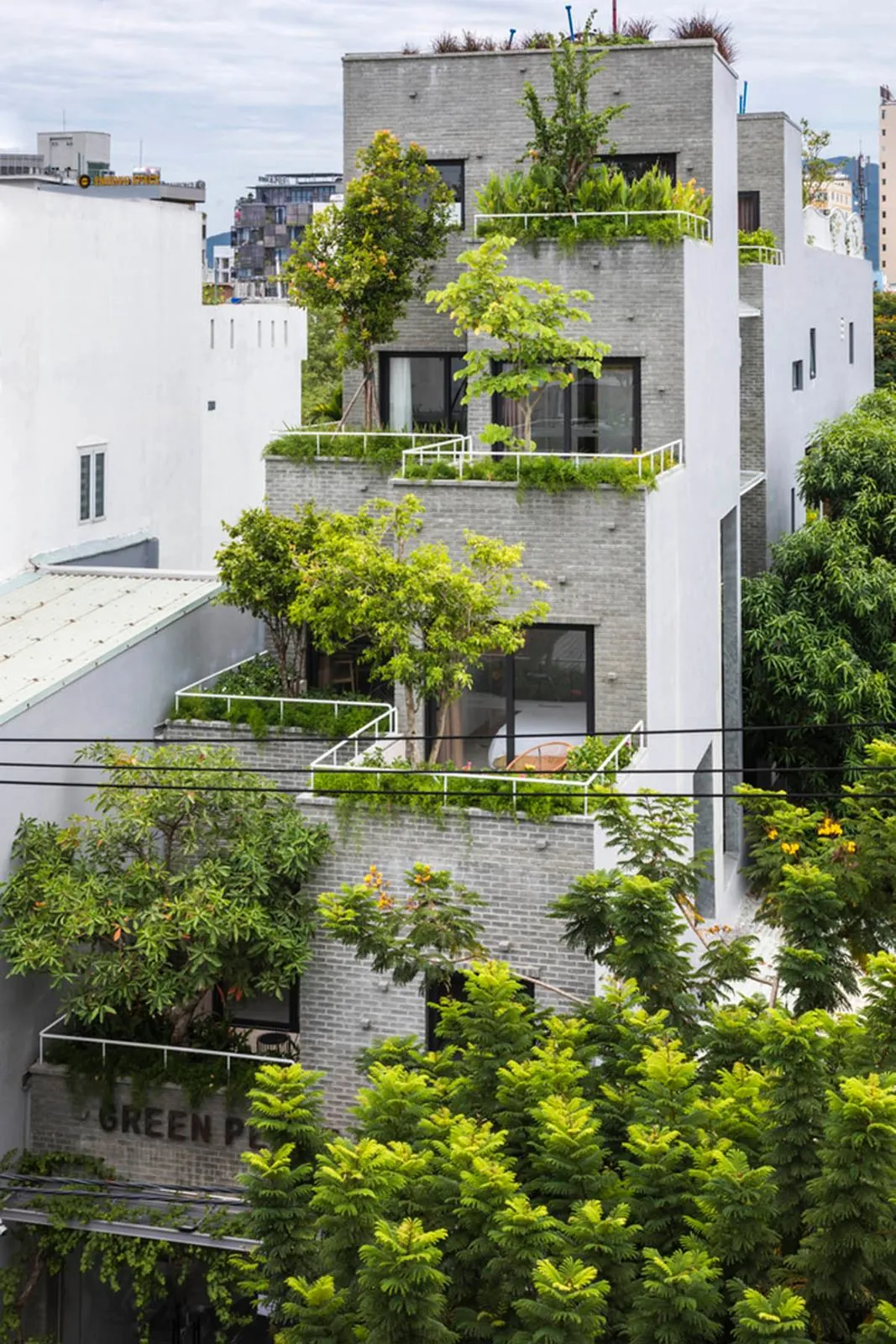 A Da Nang apartment building with plants growing on every balcony