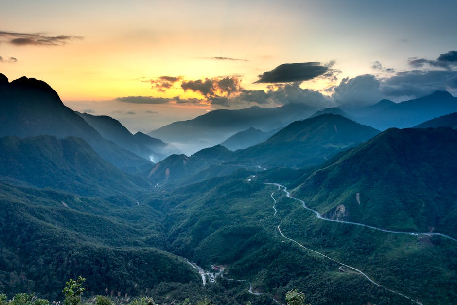 Sunset over the mountains of Central Vietnam with a winding road in the valley below
