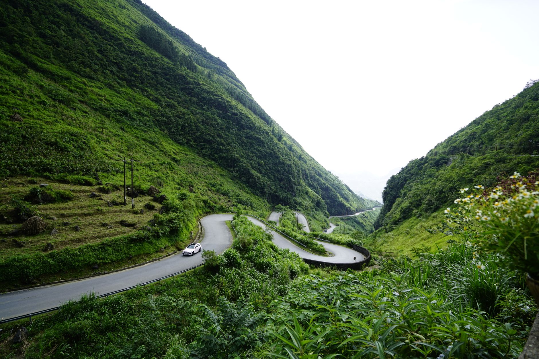 Winding mountain road above a green valley on the Ho Chi Minh Road in Vietnam