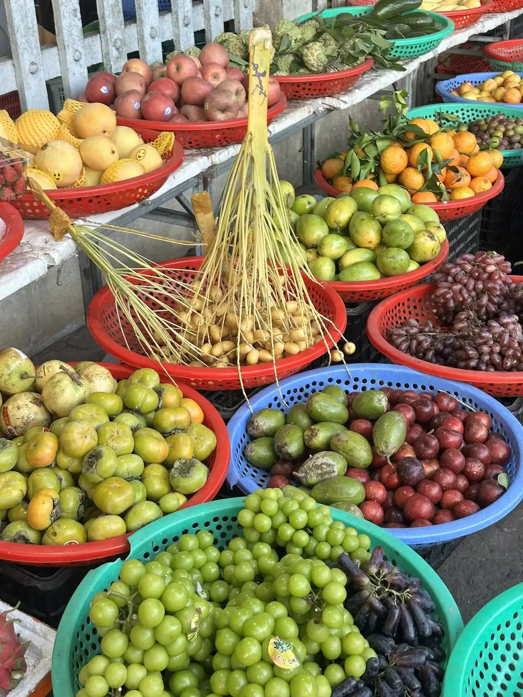 Baskets of fruit on a market stall in Hoi An