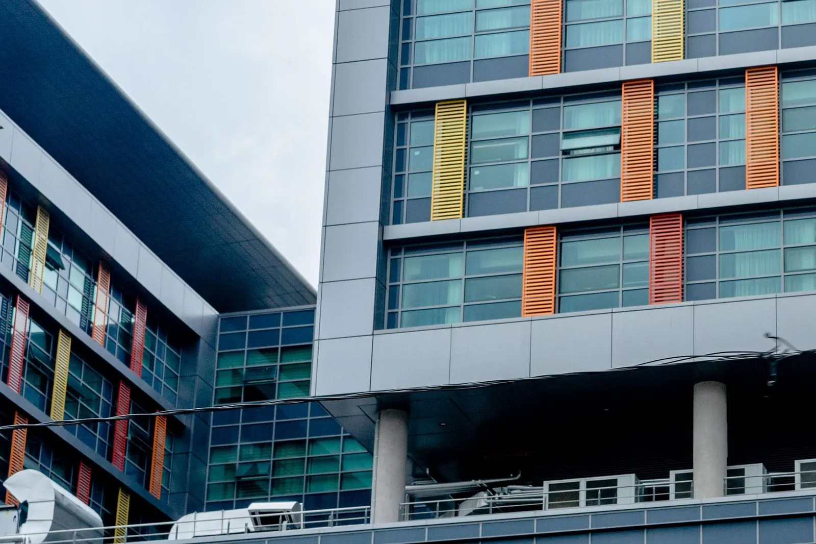 Modern multi-story hospital building facade with glass windows