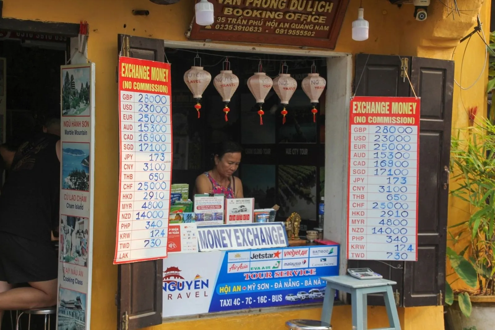 Street currency exchange booth in Vietnam with posted rates