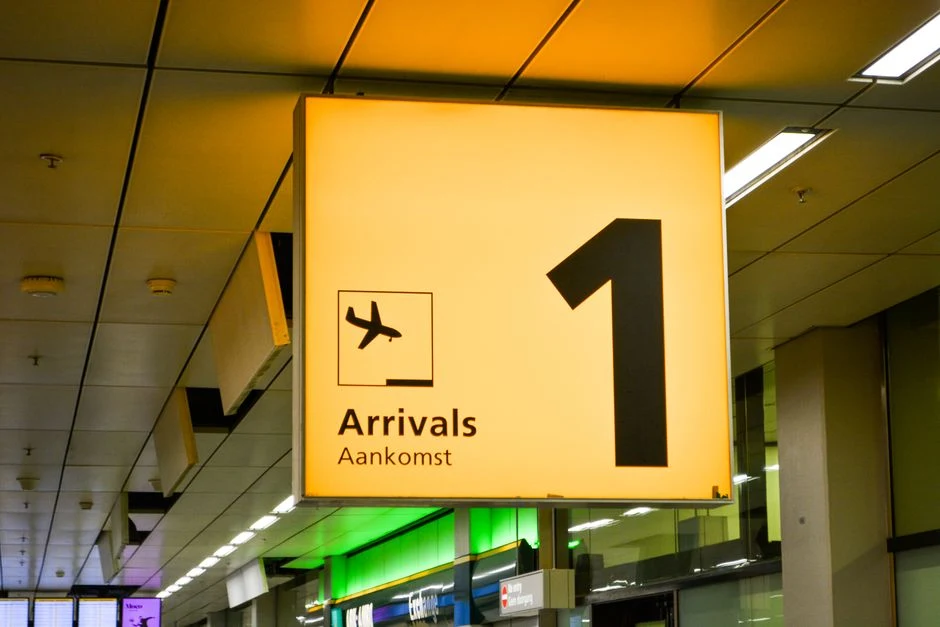 Airport arrivals sign with airplane symbol at an international terminal