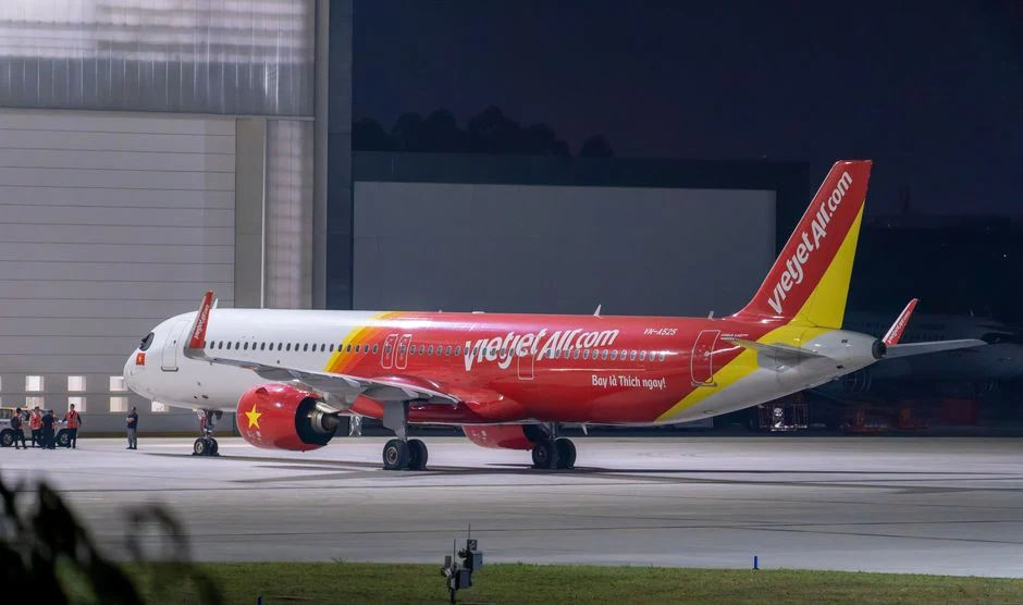 VietJet airplane parked on runway at night ready for departure