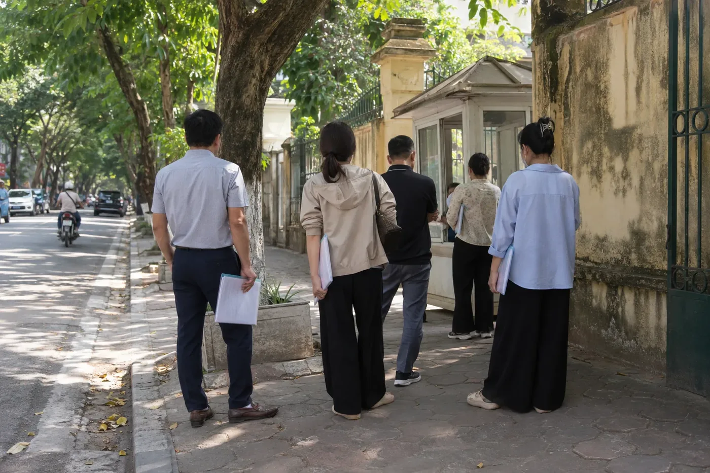 People waiting in a queue at the entrance of a consular office