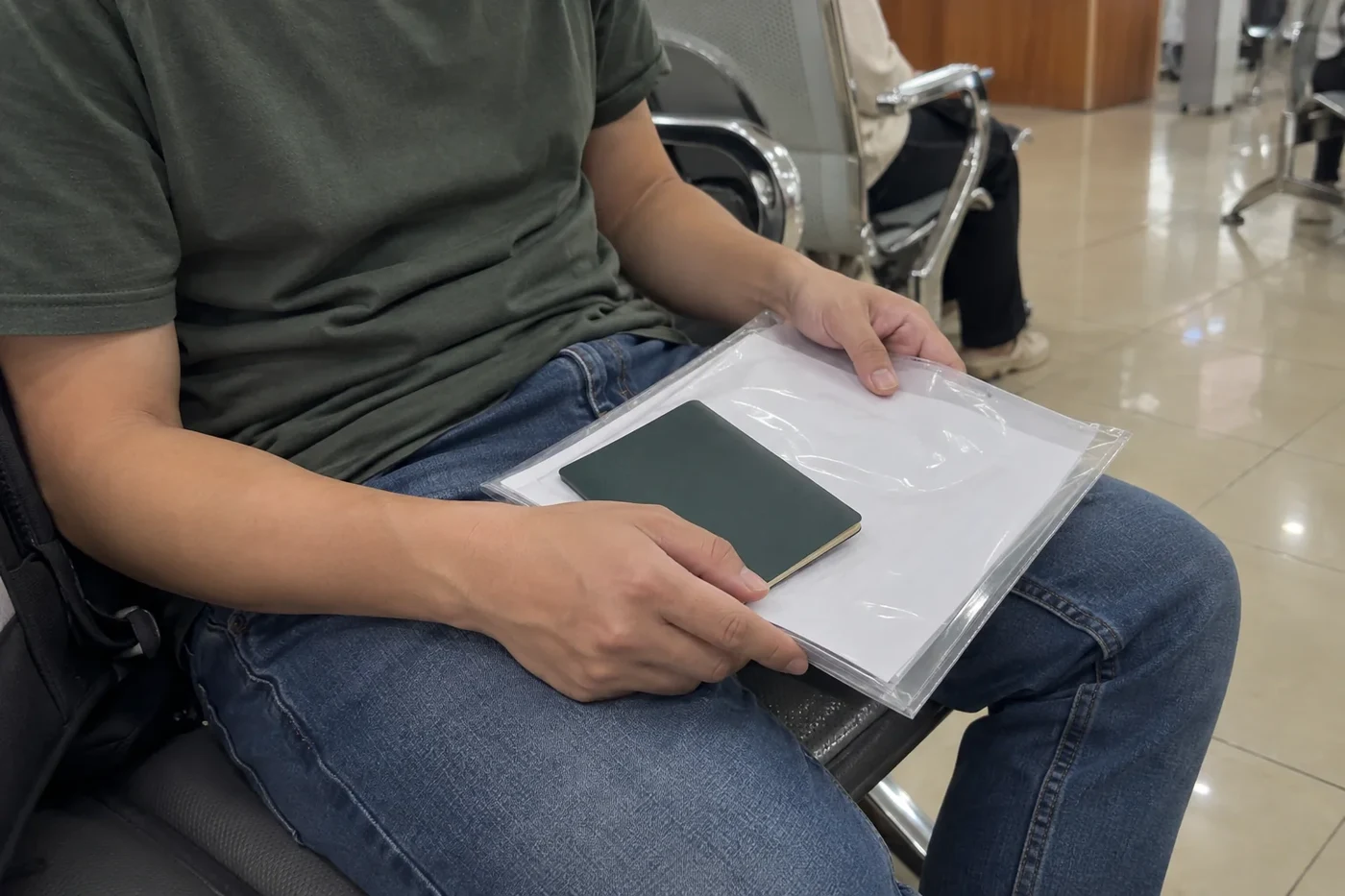 Folder of documents on a person’s lap while waiting