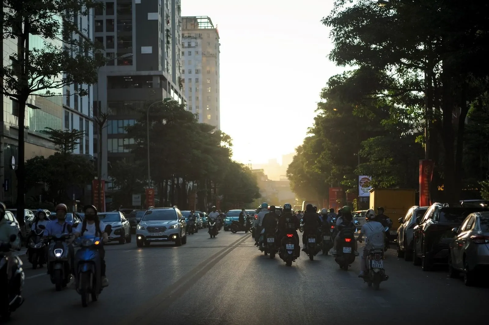 Motorbike traffic on a Vietnamese city street at dusk