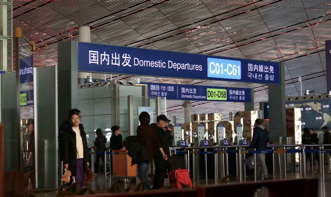 Travelers moving through a border checkpoint terminal