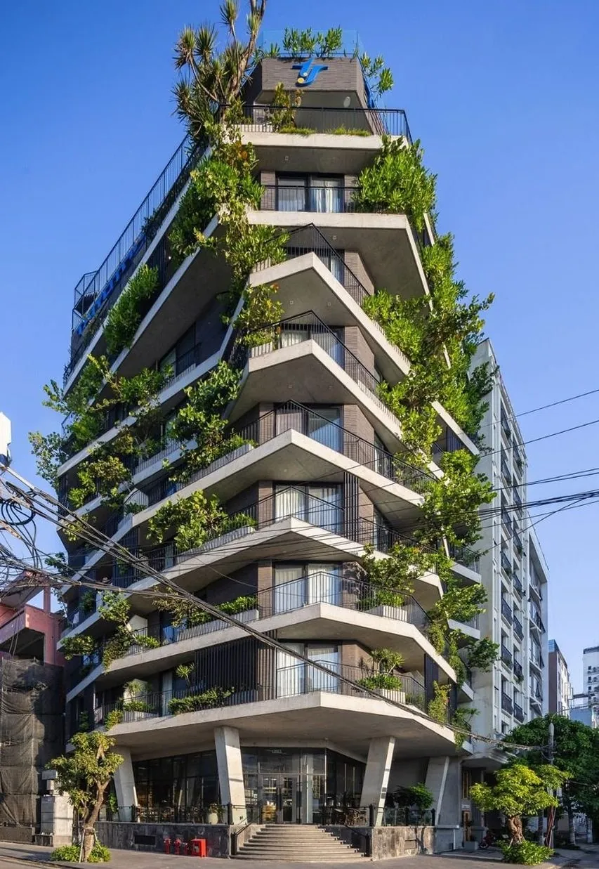Modern apartment building in Vietnam with a green plant-covered facade