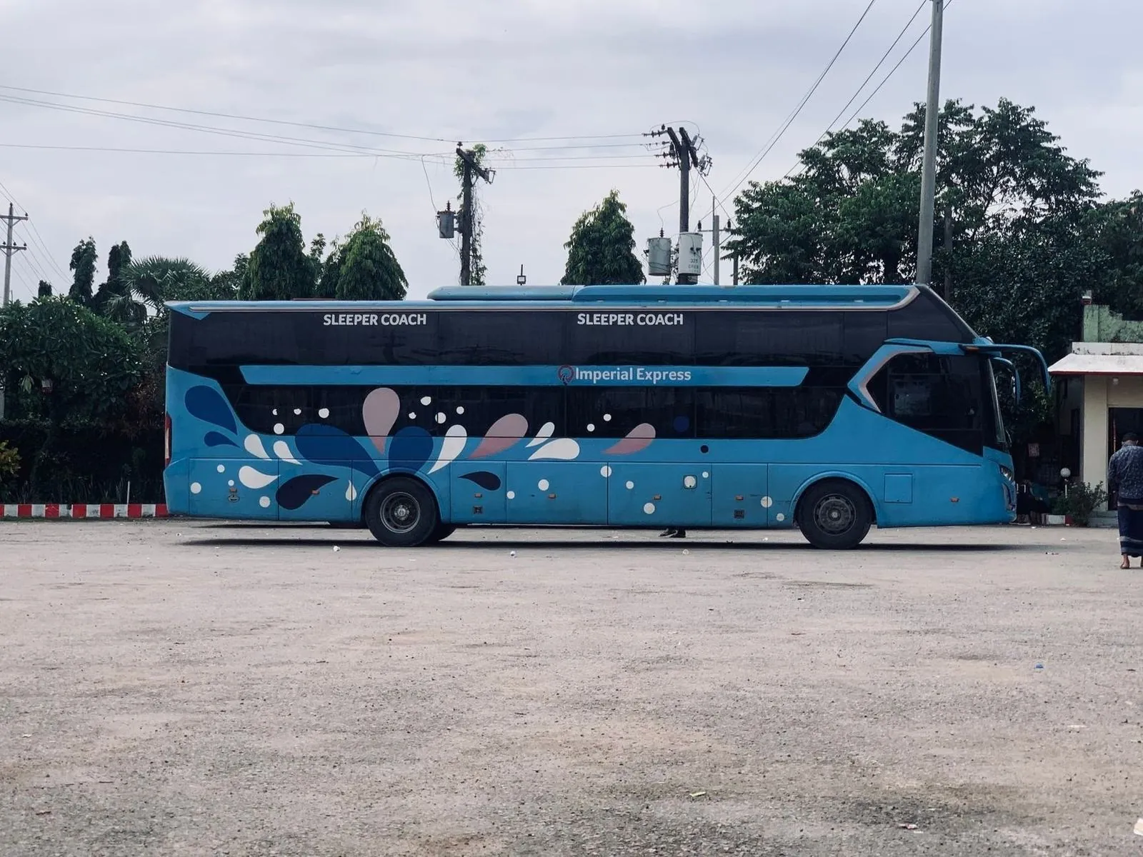 Blue sleeper coach bus parked with Sleeper Coach signage