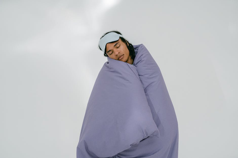 Traveler wrapped in a blanket — essential for cold bus AC