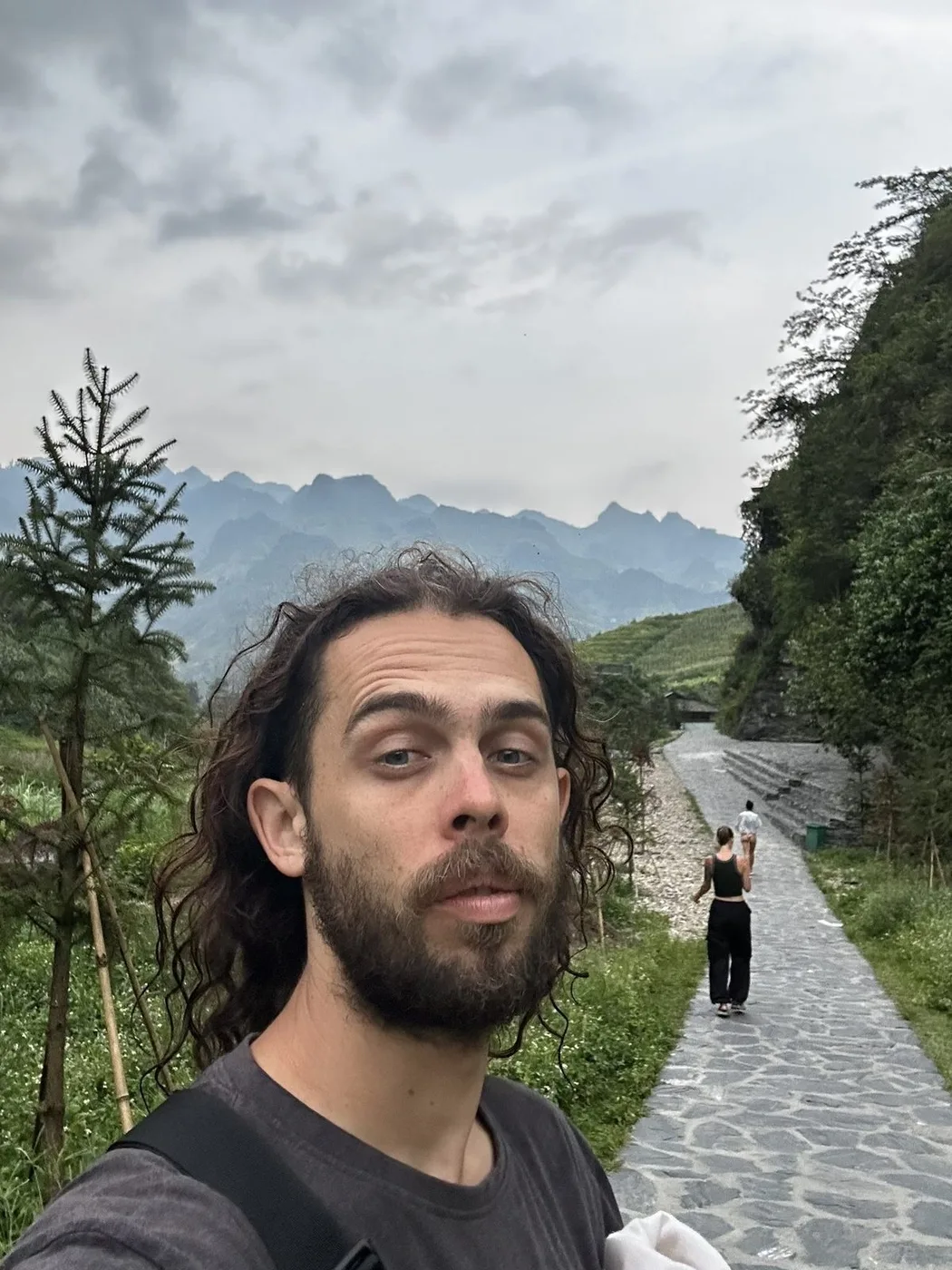 The author on a stone path among the karst mountains of Ha Giang