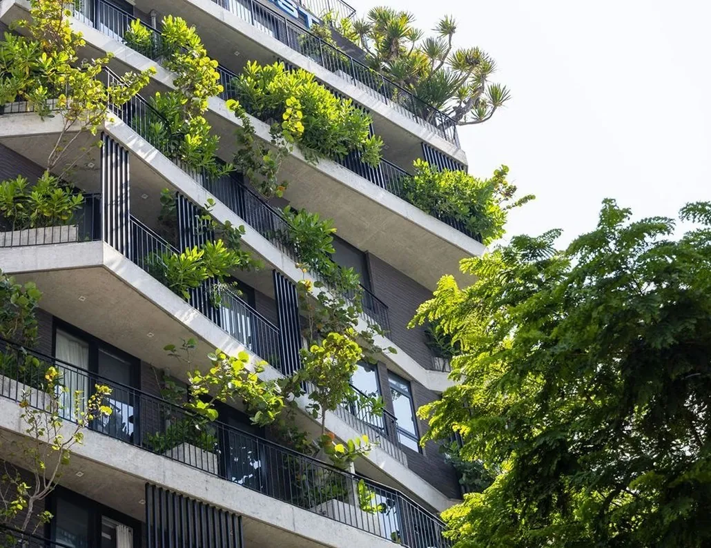 apartment balconies covered in greenery on a Da Nang building