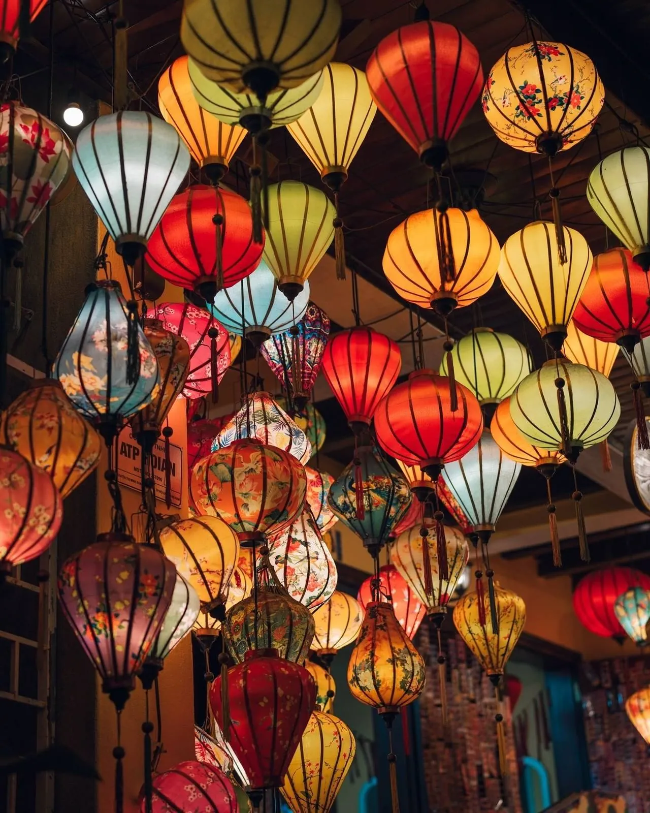 colorful silk lanterns hanging above a Vietnamese street