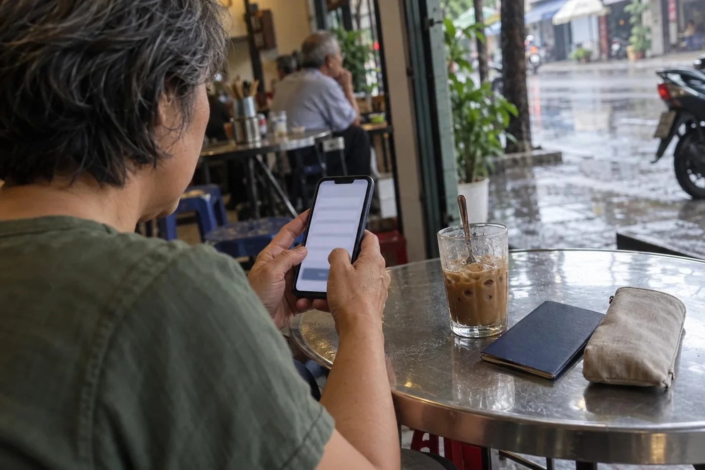 Phone on a cafe table with an online form open on the screen