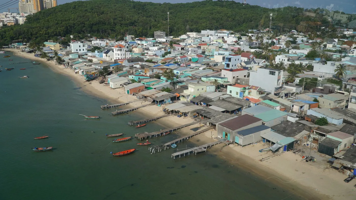 Aerial view of houses and wooden piers along the Phu Quoc shoreline