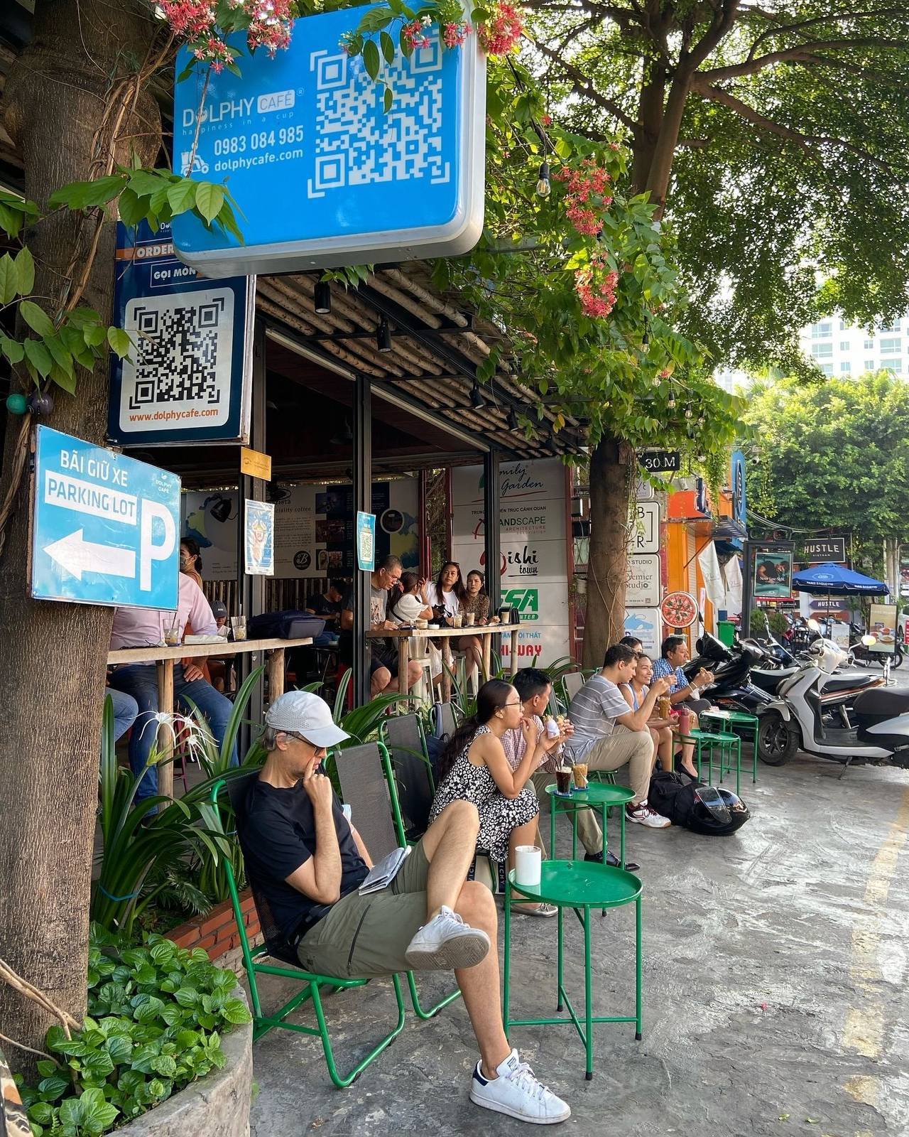 Street cafe in Vietnam with QR-code menus and parking signs
