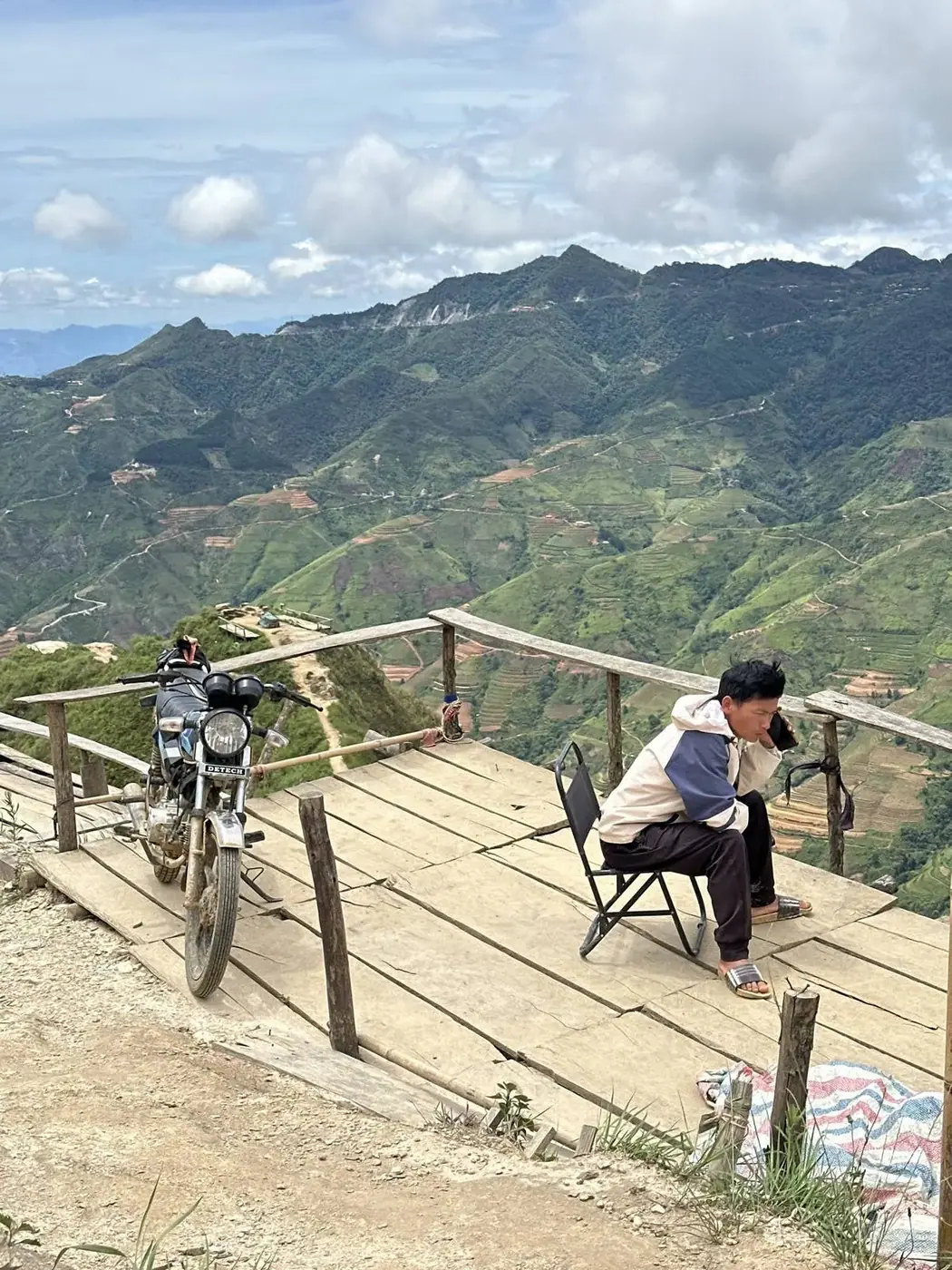 Motorbike parked at a mountain viewpoint over rice terraces