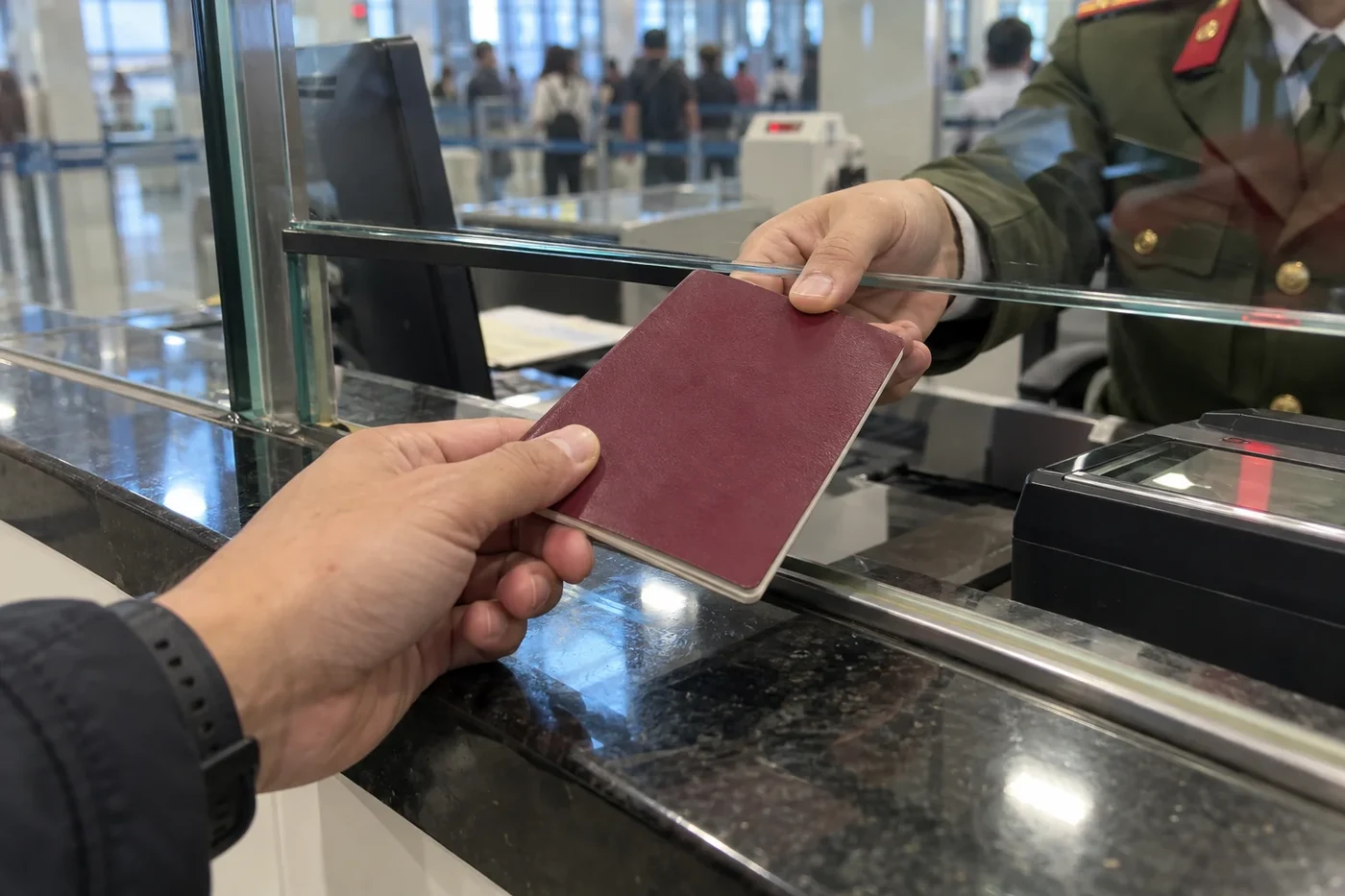 A passport passed through a counter window for checking