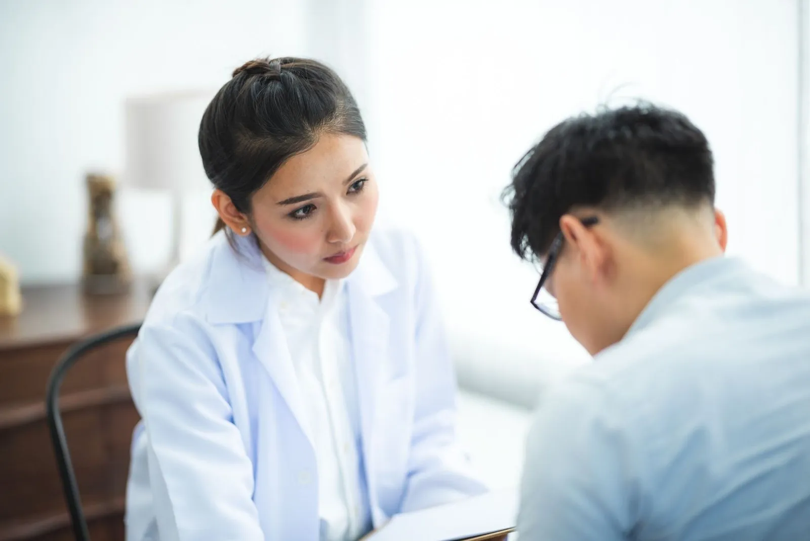Doctor reviewing medical notes with a patient