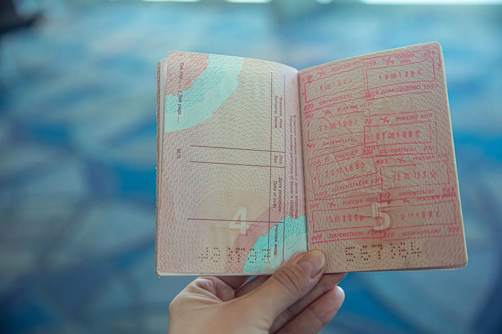 Russian passport open to pages showing entry and exit visa stamps
