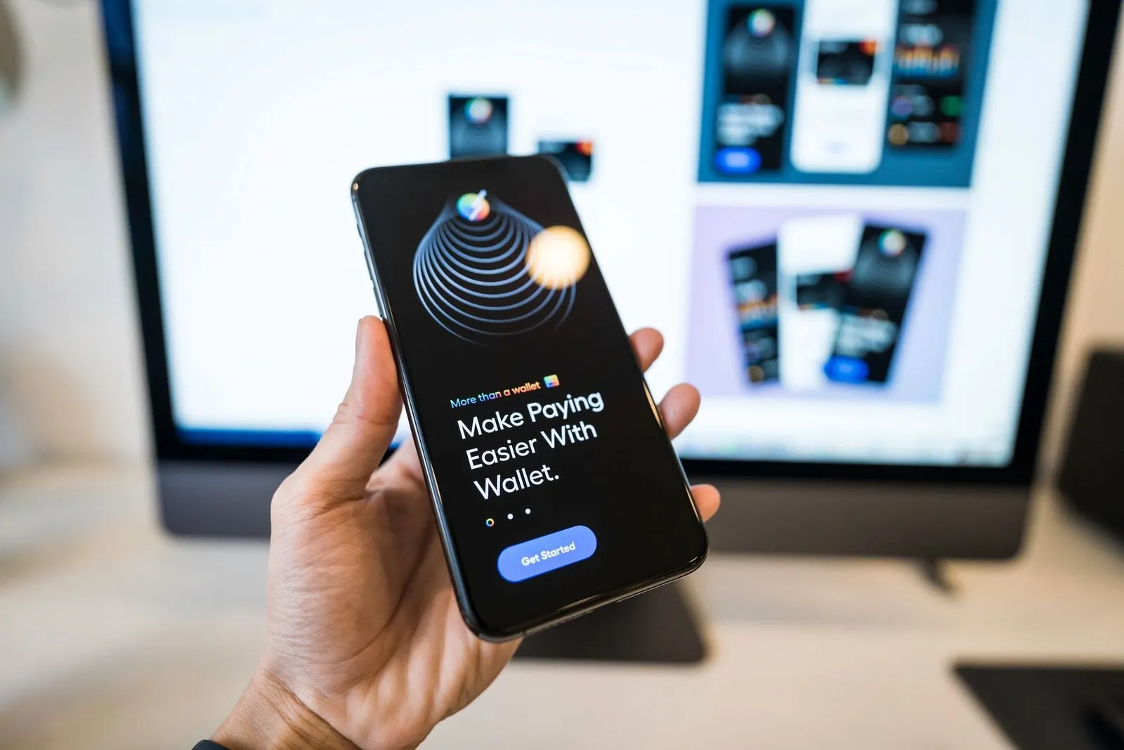 Hand holding a smartphone showing a digital wallet payment app screen