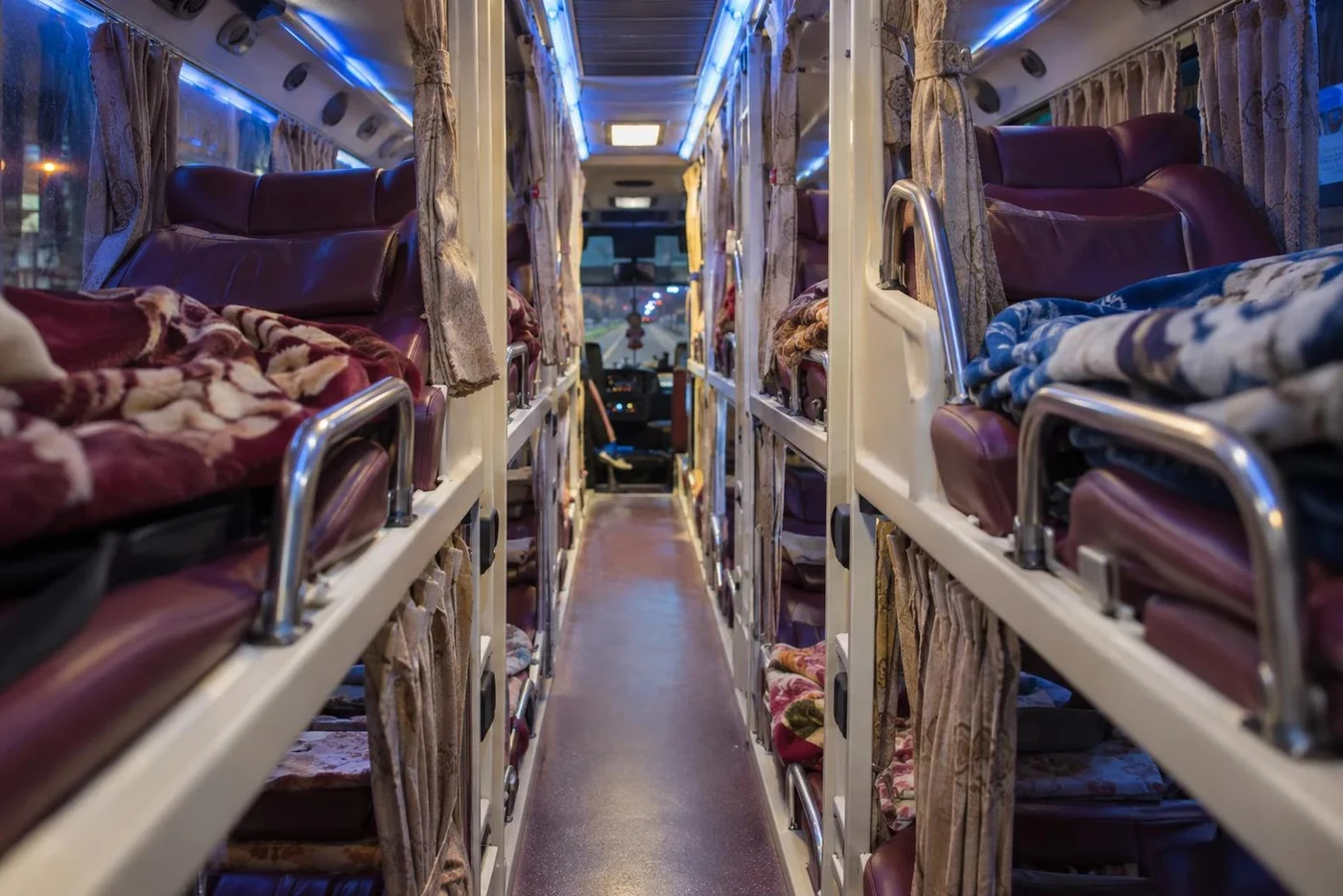 Aisle between upper and lower bunks inside a sleeper bus