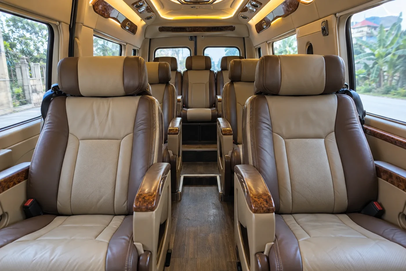 Rows of reclining leather seats inside a limousine van