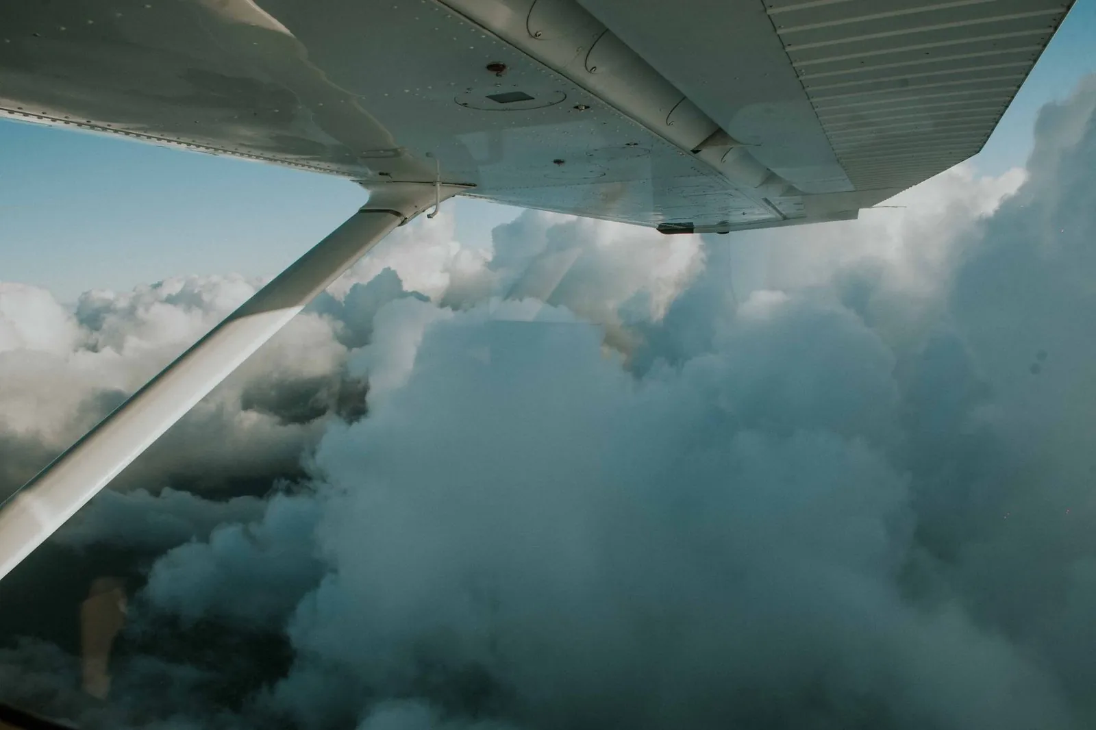 Clouds from an airplane window — flying beats 17+ hours on the ground