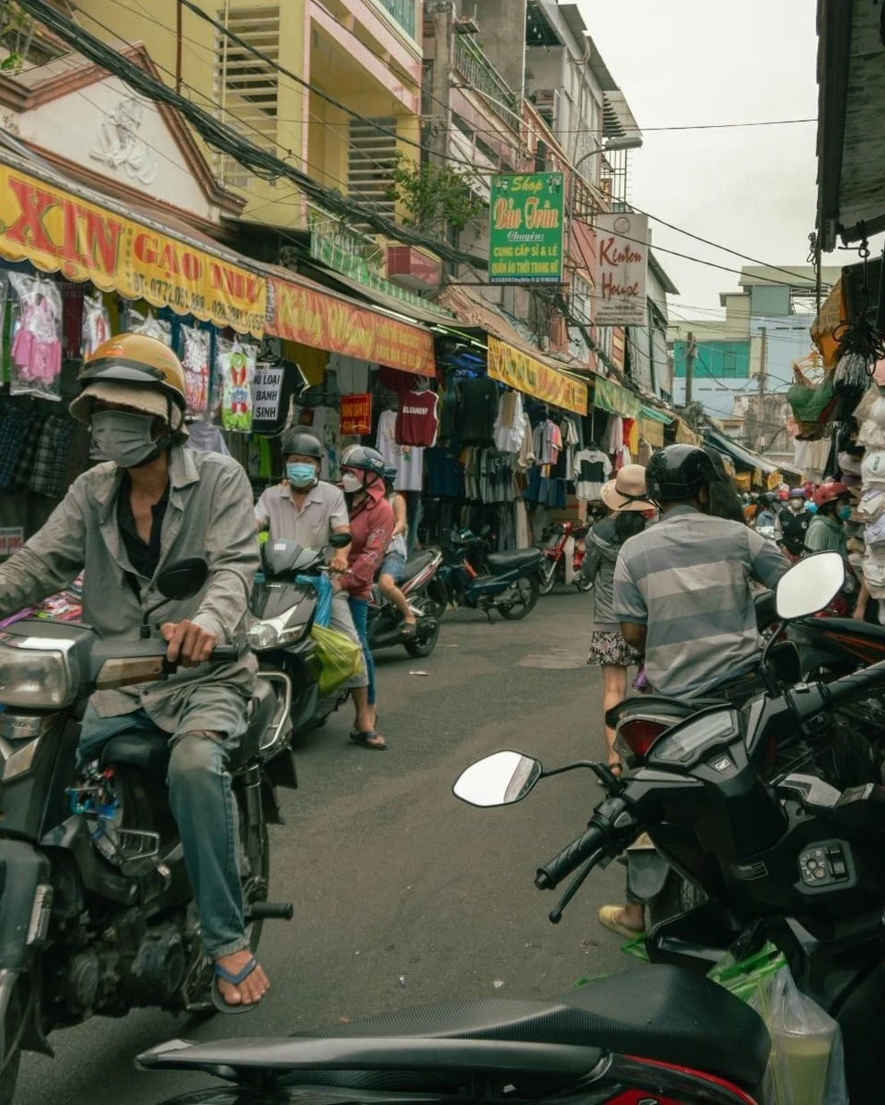 Motorbikes riding through dense traffic on a Vietnam street