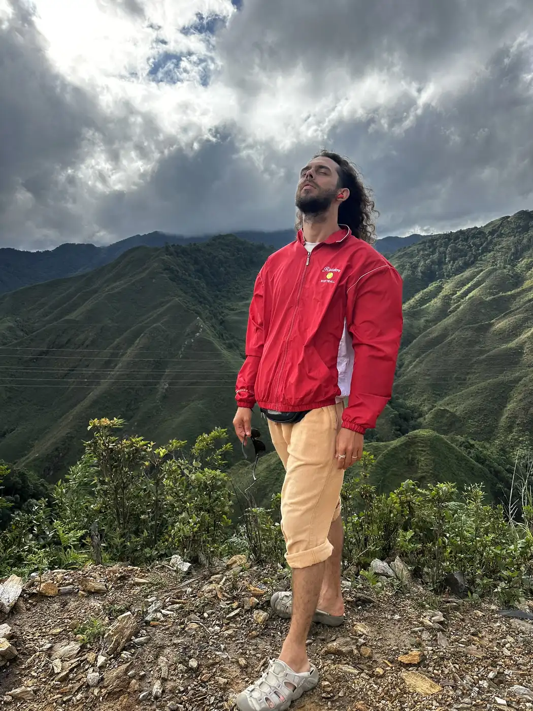 Traveler at a mountain viewpoint overlooking Moc Chau, Vietnam