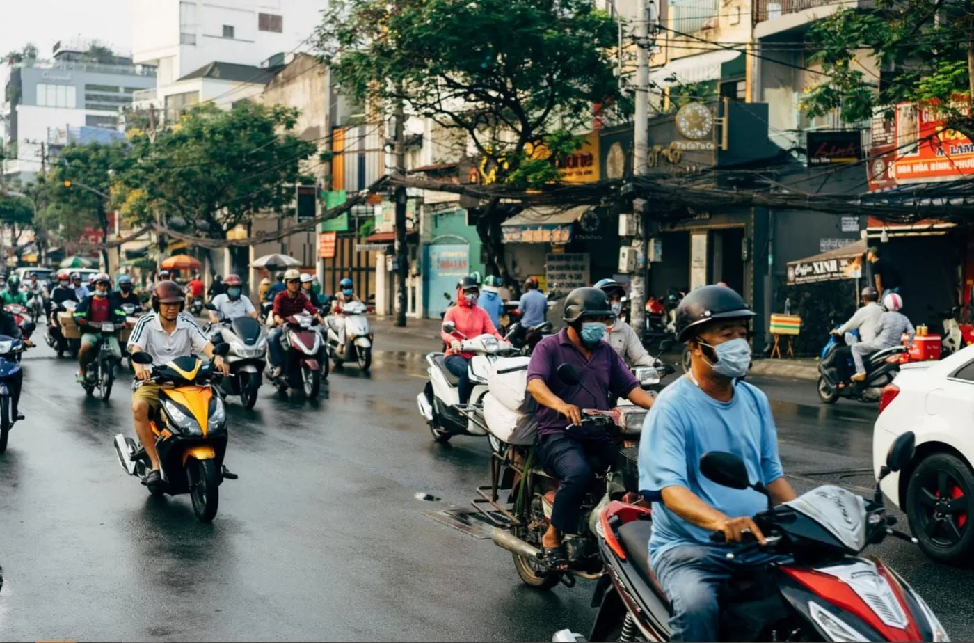 Scooters moving through a busy street in Ho Chi Minh City, Vietnam