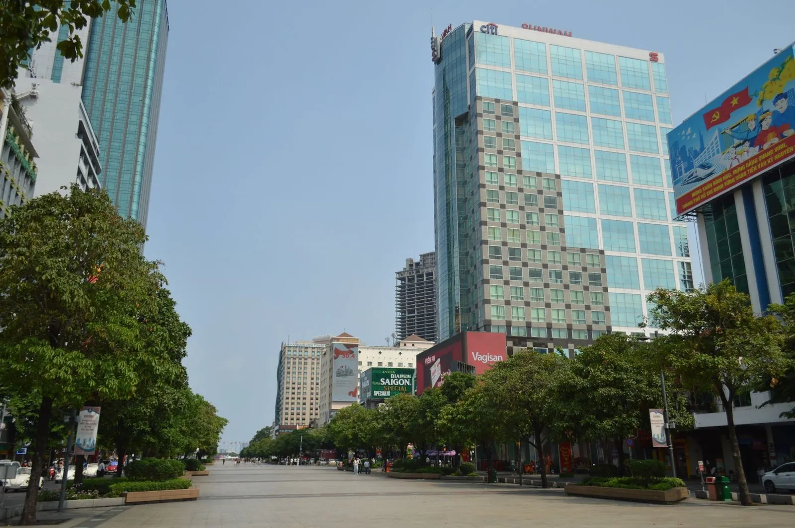 Modern office towers and bank branches along a central Ho Chi Minh City boulevard