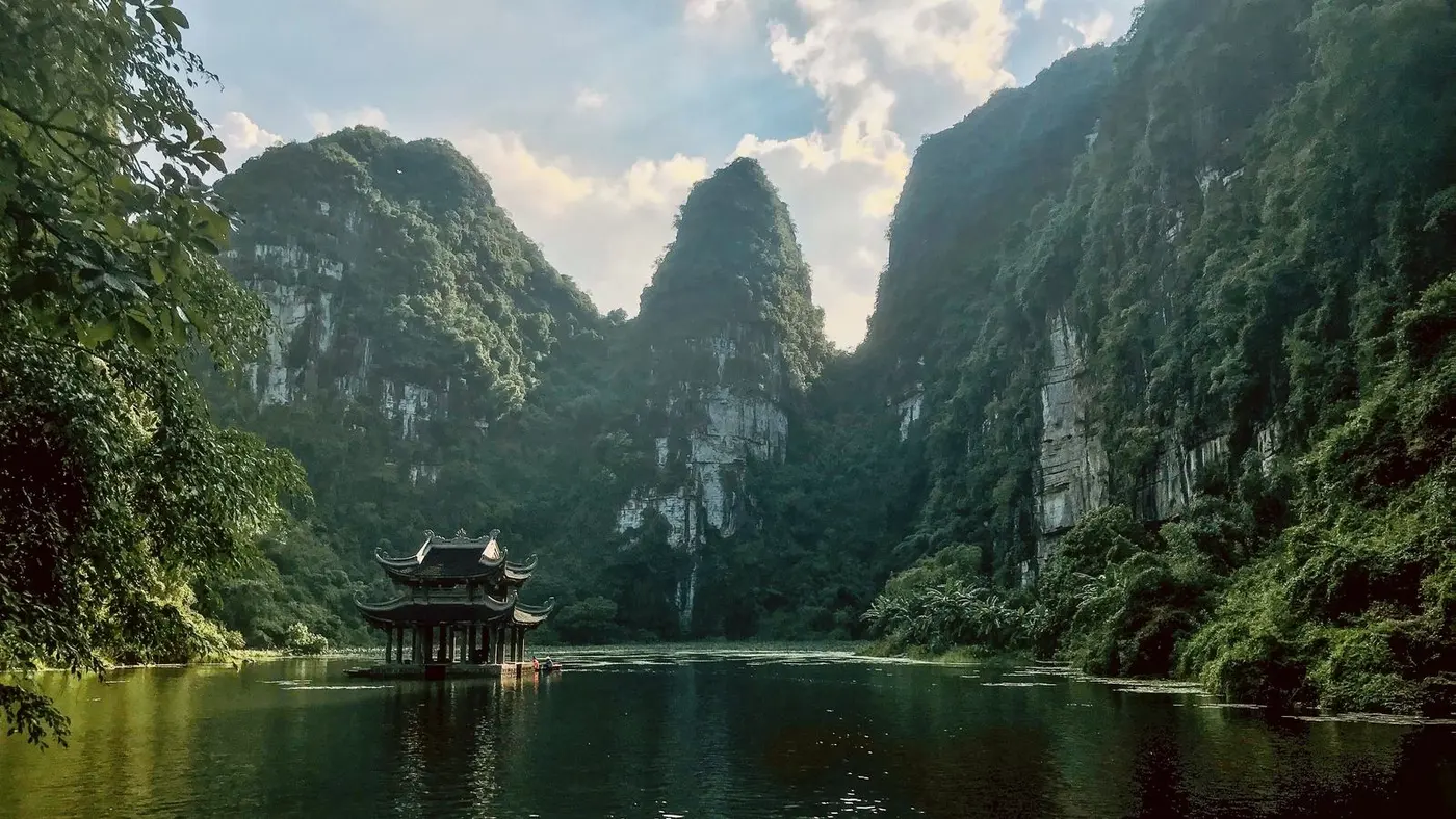pagoda on the water surrounded by limestone karsts at Trang An