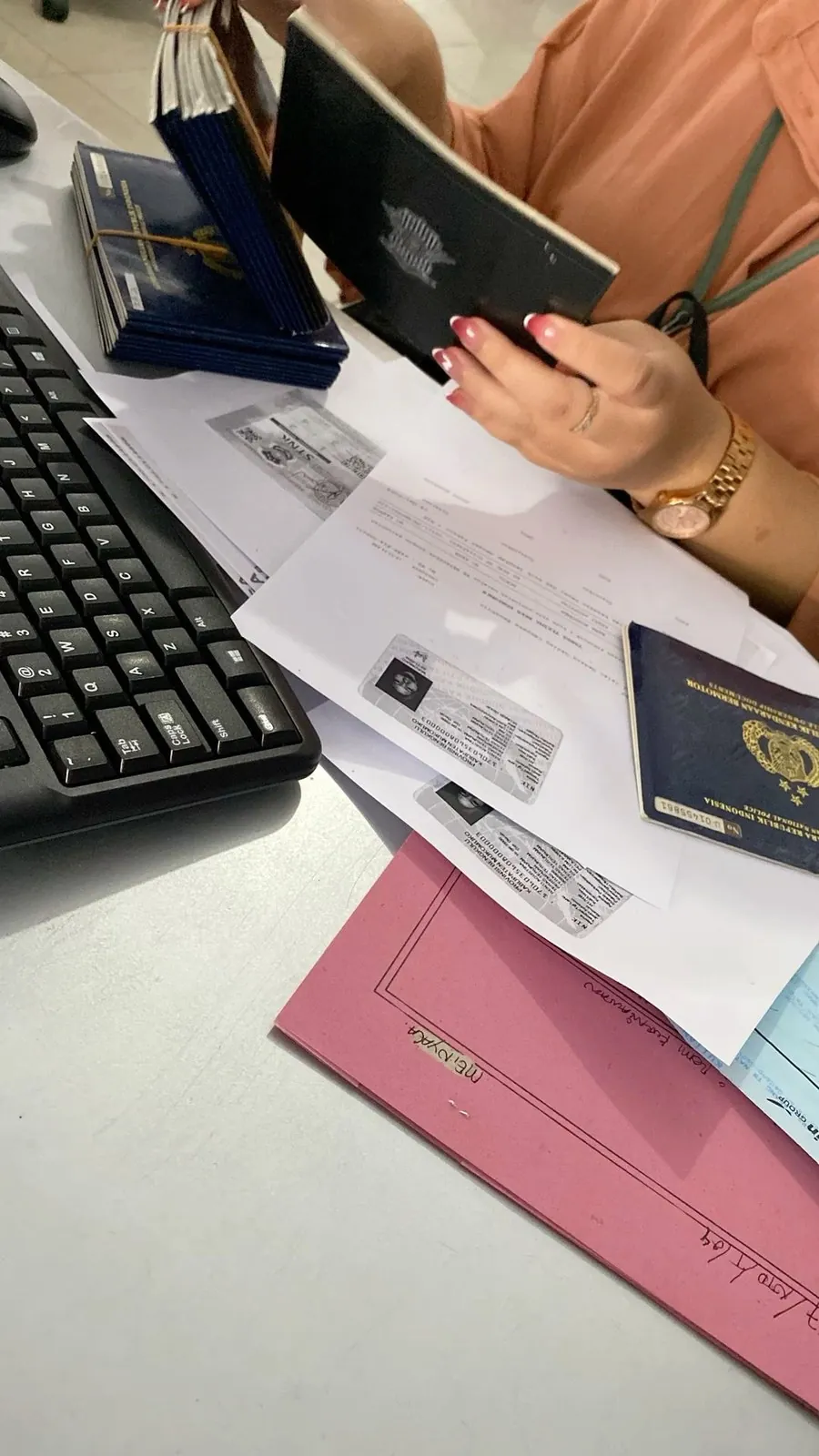 Woman completing an online pre-arrival declaration on a laptop with her passport