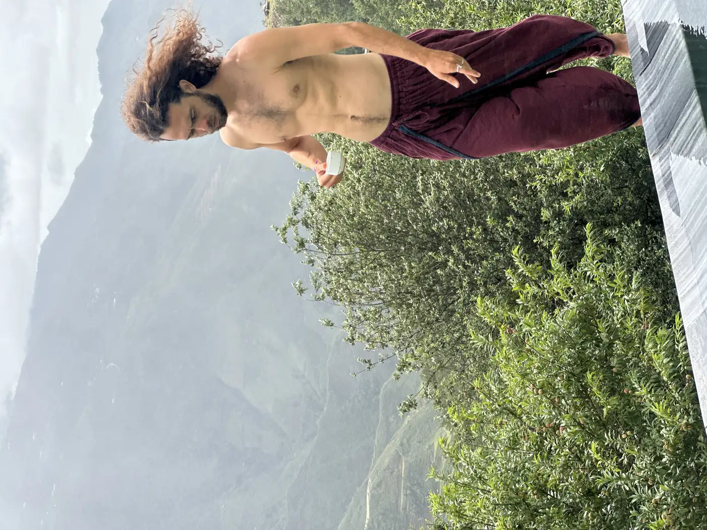 Traveler walking a terrace above misty Sapa hills