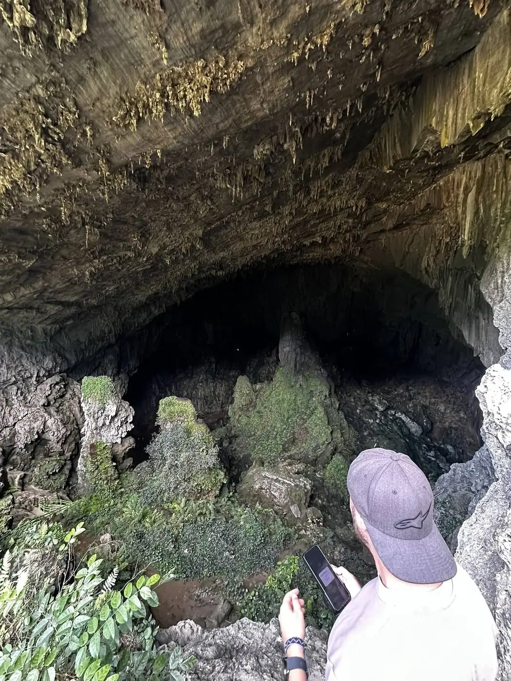 Visitor exploring Phong Nha cave entrance in Vietnam