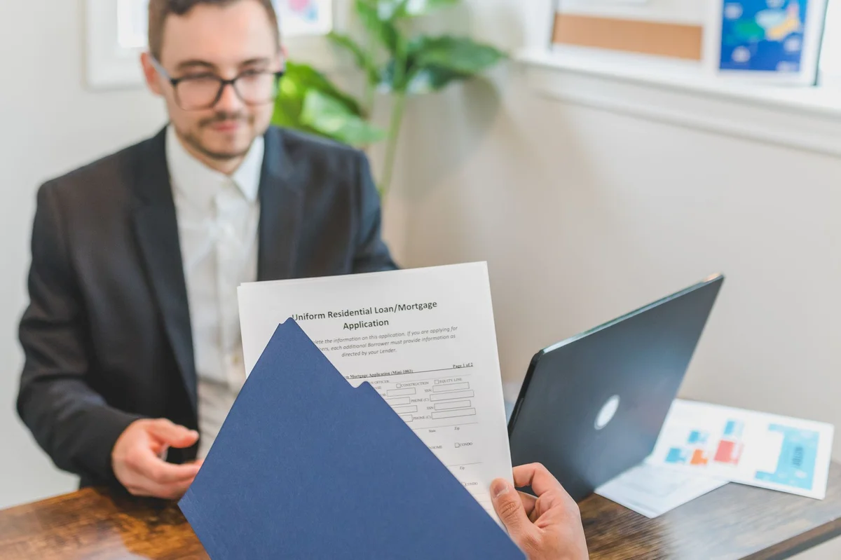 Mortgage broker presenting loan documents to client