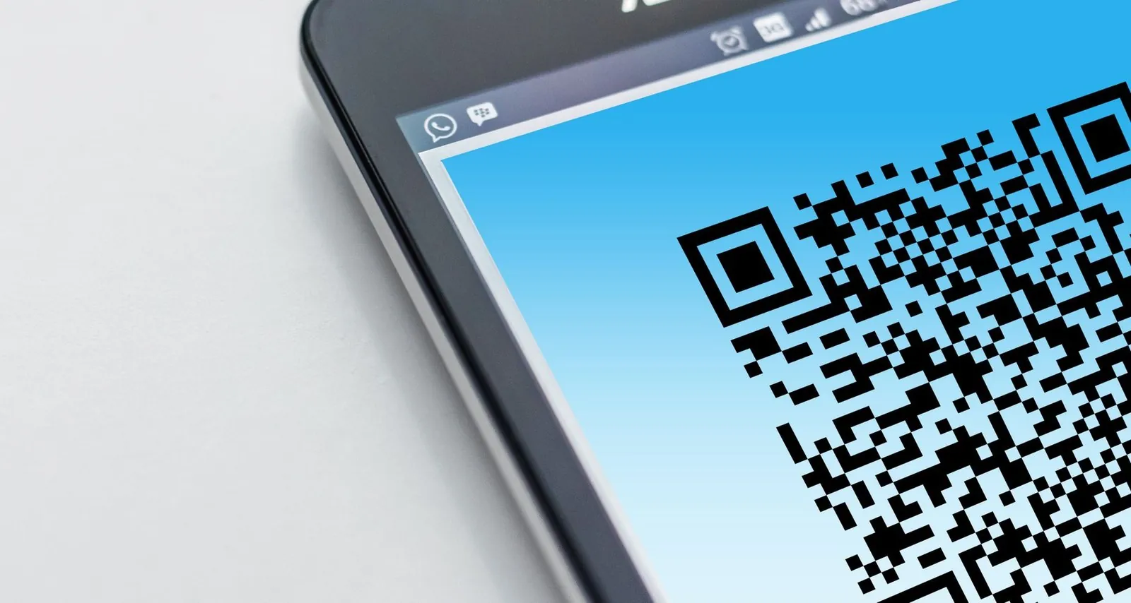 A smartphone screen displaying a black-and-white QR code for payment